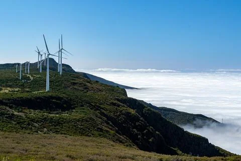 Wind turbines park generating renewable electricity  high in mountains Stock Photos