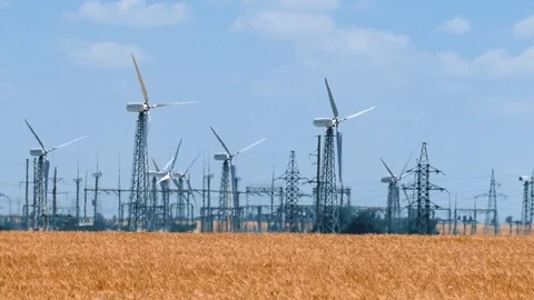 Wind turbines with power lines in foreground Stock Footage 77087735