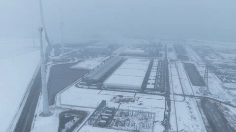 Wind turbines powering data center in winter snow Stock Footage 327904281