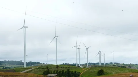 Wind turbines producing clean alternative energy in the mountains Video stock 94697848
