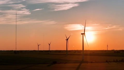 Wind turbines producing clean energy at sunset Vídeos de archivo 340952865