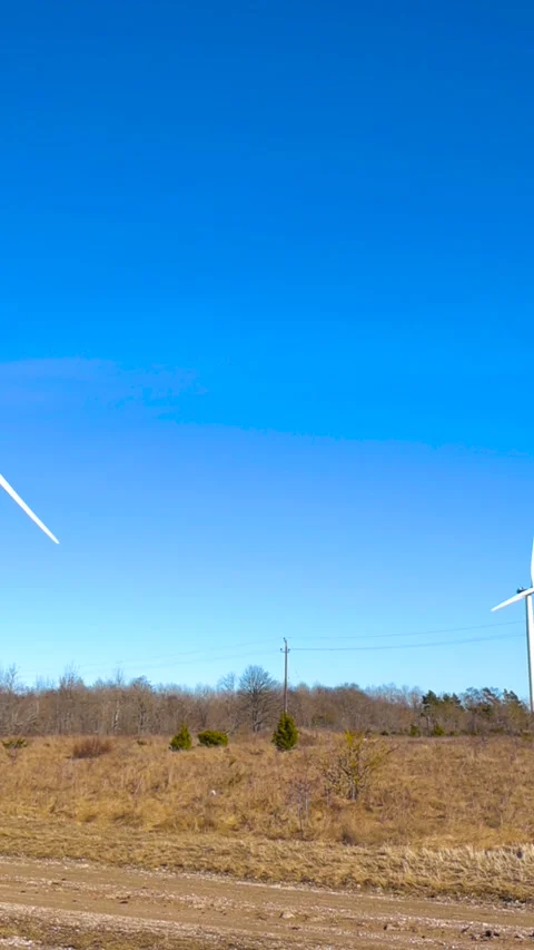 Wind Turbines Producing Renewable Energy on a Sunny Day Stock Footage 332628540