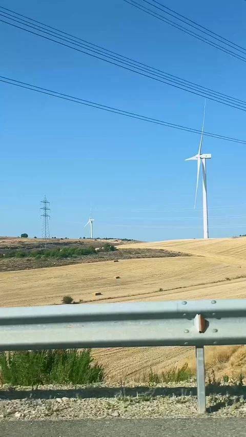 Wind turbines producing renewable energy in a rural landscape seen Video stock 343353465