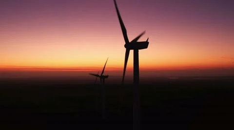 Wind turbines producing renewable green energy in California at sunset Stock Footage 61376267