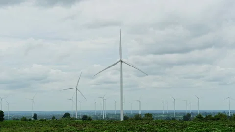 Wind turbines producing renewable wind energy under overcast sky Video stock 342906474