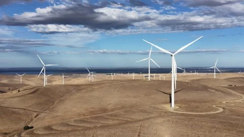 Wind Turbines On Rolling Hills Under Partly Cloudy Sky Stock Footage 345216484
