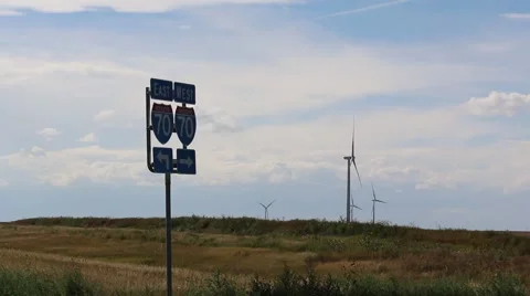 Wind Turbines Rotate Behind Interstate 70 Road Sign Stock Footage 54801417