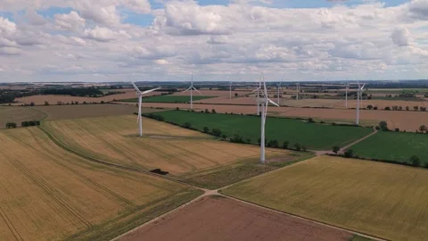 Wind Turbines Rotate in the Green Fields of England During a Bright Sunny 库存影片 341838188