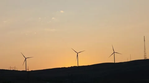 Wind turbines rotating during sunset on a hill Stock-Footage 315357774