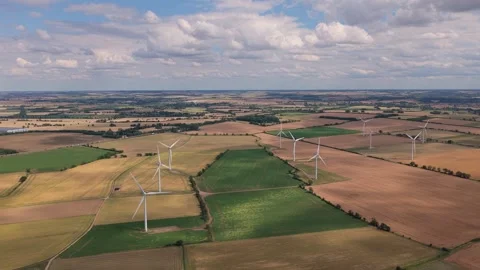 Wind Turbines Rotating in Fields Across the English Countryside During a Sunny Stock Footage 341838236