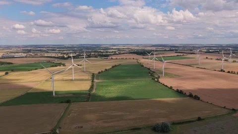 Wind Turbines Rotating in Fields During a Sunny Afternoon Over the English Stock Footage 341838106