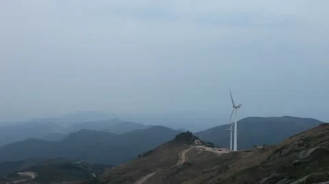 Wind turbines rotating on hill Stock Footage 22149577
