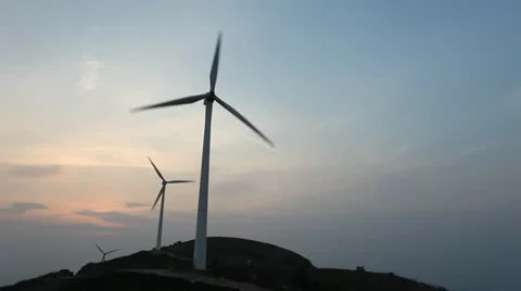 Wind turbines rotating on hill Stock Footage 22150944