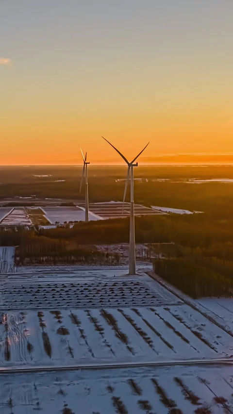Wind Turbines Rotating Over Snowy Fields at Sunset in Winter Timelapse Landscape Stock Footage 340141068