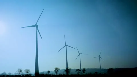 Wind Turbines rotating in slow motion on Sunny Blue Sky in Winter Stock-Footage 107313234