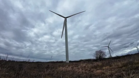 Wind turbines rotating under dramatic cloudy sky Stock Footage 337535799