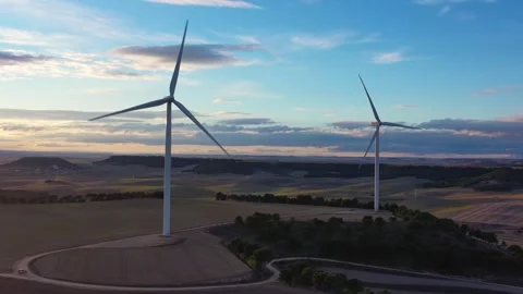 Wind Turbines Rotating Under Partly Cloudy Sky in the Afternoon Stock Footage 325528376