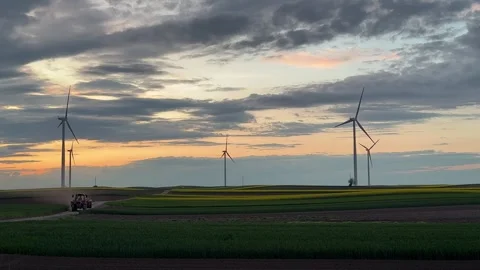 Wind Turbines Silhouetted Against Dramatic Sunset Sky Video stock 335810712