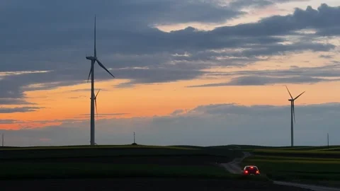 Wind Turbines Silhouetted Against Dramatic Sunset Sky Video stock 335810843