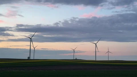 Wind Turbines Silhouetted Against Dramatic Sunset Sky Stock Footage 335810876