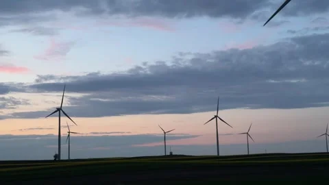 Wind Turbines Silhouetted Against Dramatic Sunset Sky Stock Footage 335810891
