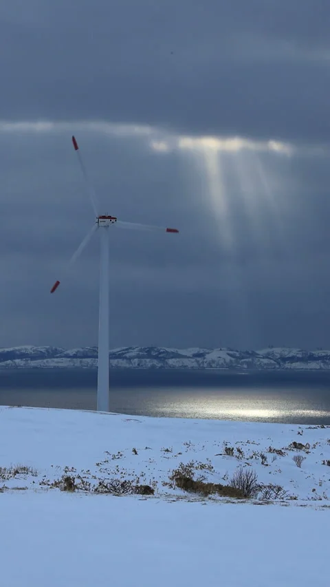 Wind Turbines, Snowfields, and the Rays of the Setting Sun Stock Footage 324968153
