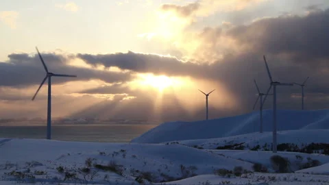 Wind Turbines, Snowfields, Flowing Clouds, and the Sunset Stock Footage 324967105