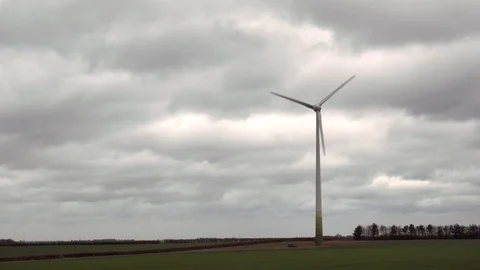 Wind turbines spin on background of dark clouds Stock Footage 104791942