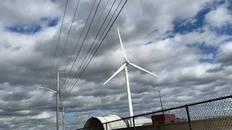 Wind Turbines Spin in a Cloudy Sky on a Windy Day in the Countryside Stock Footage 317632274