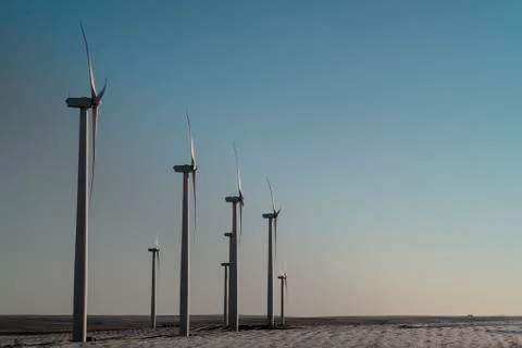 Wind Turbines Spin Into The Setting Sun Stock Photos
