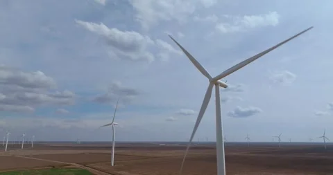 Wind Turbines Spinning Against Dramatic Cloudy Sky Texas Aerial Rising Shot Stock Footage 334711040