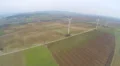 Wind turbines spinning on beautiful green fields, countryside. Renewable energy 4k or 4k+ Resolution