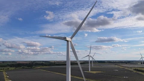 Wind Turbines Spinning in a Large Solar Farm During a Bright and Sunny 库存影片 340919150