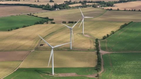 Wind Turbines Spinning Over Green and Yellow Agricultural Fields During the Stock Footage 341838134