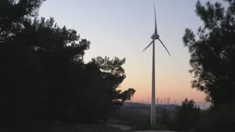 Wind Turbines Spinning on a Sunny Day in Open Countryside Sunset Sky Stock Footage 313406498