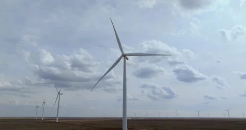 Wind Turbines Spinning Under Dramatic Cloudy Sky Over Flat Texas Plains Stock Footage 334710948