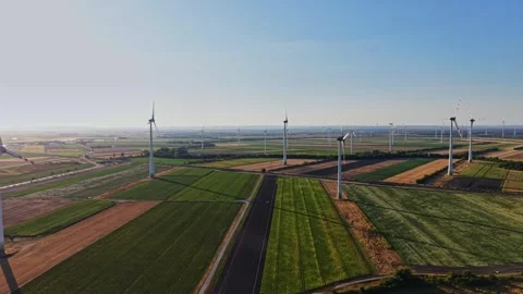 Wind turbines stand tall in open fields during bright daylight 스톡 동영상 342608378