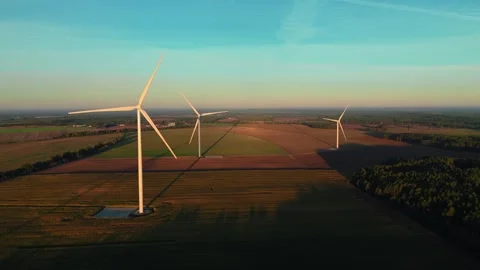 Wind Turbines Standing in Agricultural Fields at Golden Hour Stock Footage 336961861