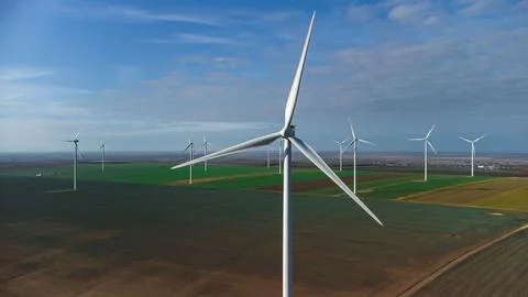 Wind turbines standing in the field from the drone point of view Stock Photos
