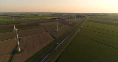 Wind Turbines, Sunset, Dutch Highway -  Friesland, The Netherlands – 4K Drone Video stock 123710098