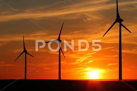 Wind turbines at sunset Stock Photos