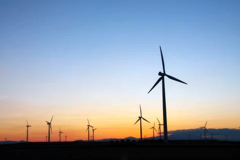 Wind turbines at sunset Stock Photos