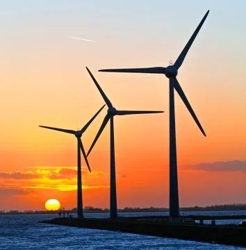 Wind turbines at sunset Stock Photos