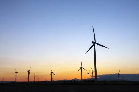 Wind turbines at sunset Stock Photos