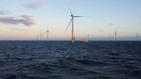 Wind turbines at sunset Stock Photos