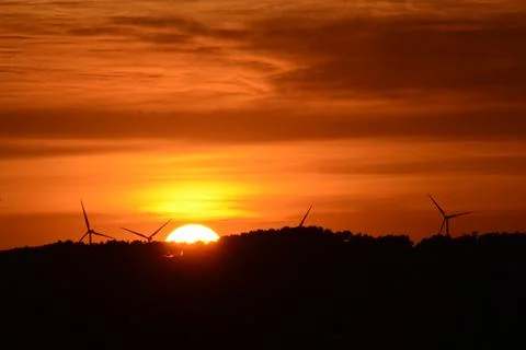 Wind turbines at sunset. Stock Photos