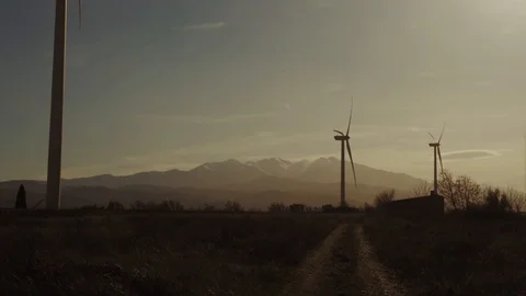 Wind turbines at sunset sky background. Slow motion. Stock Footage 127961048