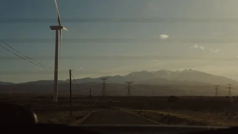 Wind turbines at sunset sky background. Slow motion. Video stock 127961067