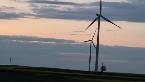 Wind Turbines at Sunset Viewed from Moving Vehicle Stock-Footage 335811021