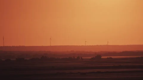 Wind turbines at sunset without clouds Stock Footage 243451055